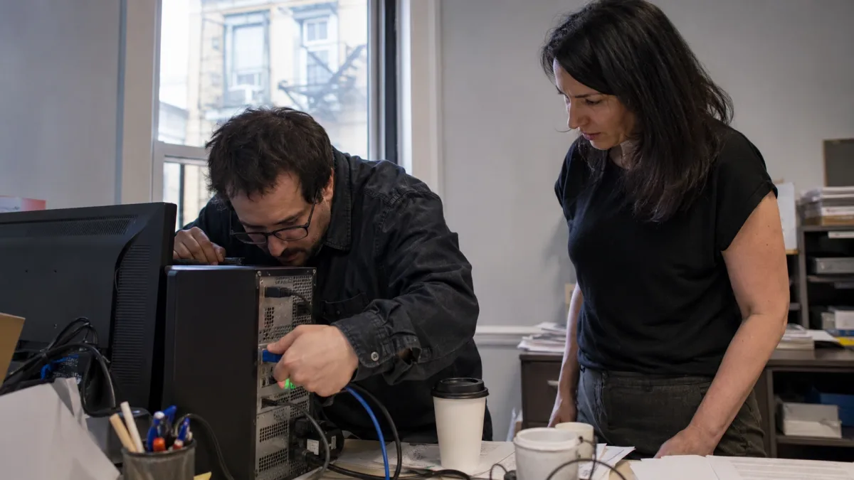Small business team isolating an infected computer by disconnecting the network cable during a ransomware incident in Montreal